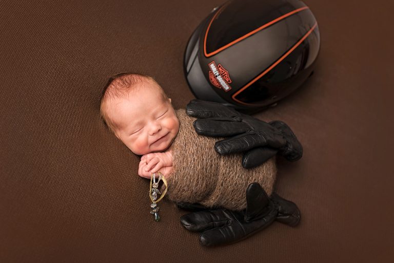 baby photographed with bike helmet and gloves by Kilkenny photographer